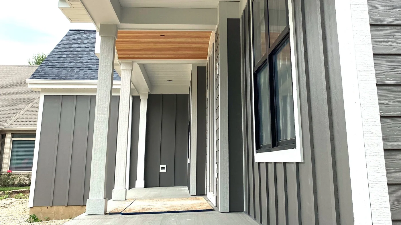 A lower view from the ground of the gray vertical siding on a house in Glenview, IL, by Apex Exteriors, Inc.