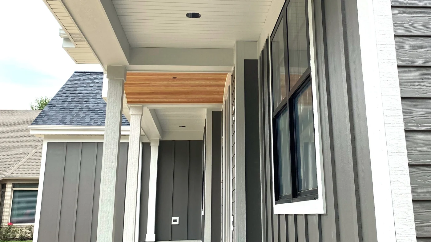 Looking up at vertical gray siding on a house in Elmhurst, IL, by Apex Exteriors, Inc.