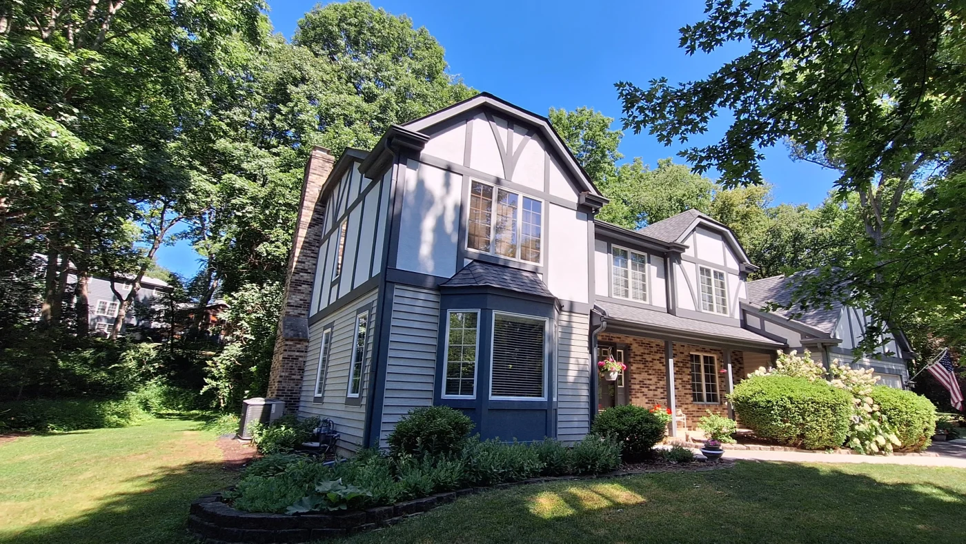 A house with multiple types of siding and a gray roof in Plainfield, IL, by Apex Exteriors, Inc.