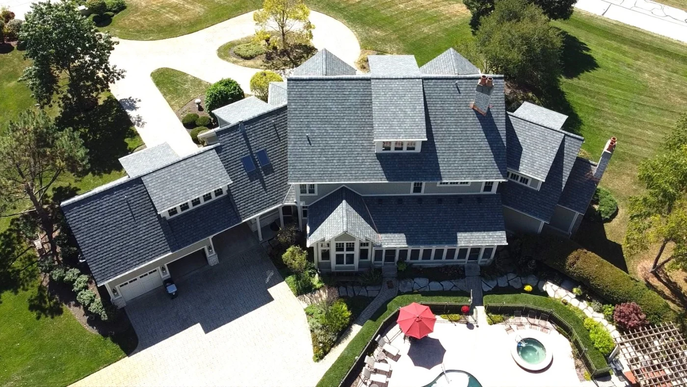 A sky view of a large house with a gray roof in Plainfield, IL, by Apex Exteriors, Inc.