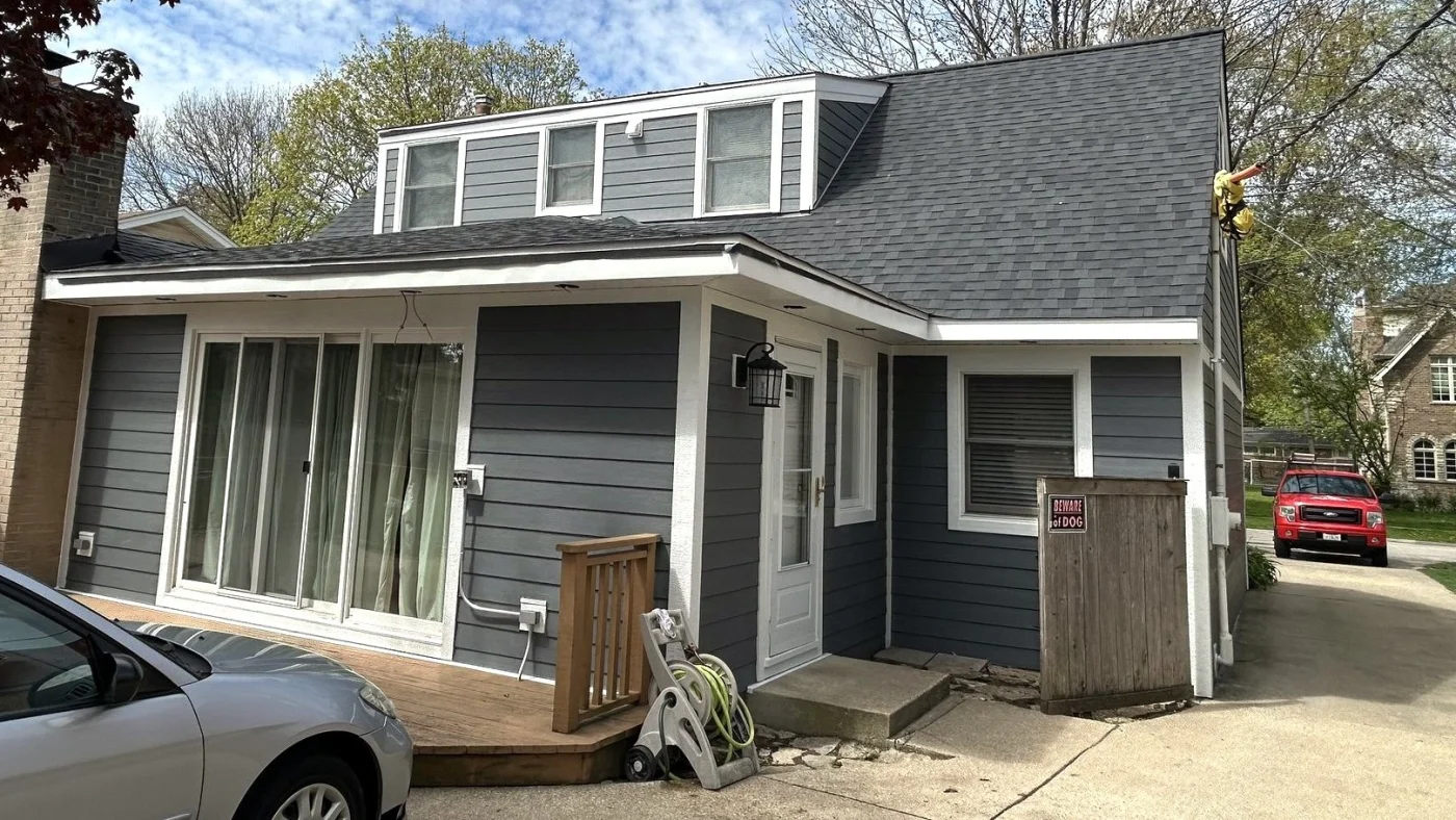 The front of a house with gray siding and white trim in Bloomingdale, IL, by Apex Exteriors, Inc.
