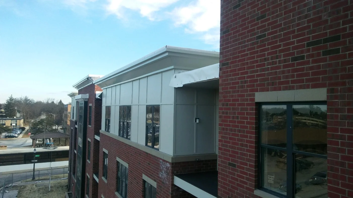 Reliable Commercial Roofing Experts Wheaton Il Apex Exteriors The side of a commercial building looking towards the roofline in Wheaton, IL, by Apex Exteriors