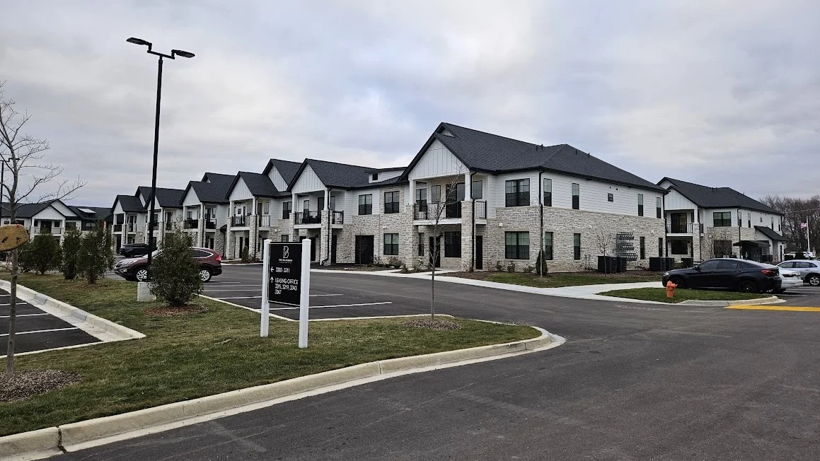An apartment complex with white siding and a gray roof in Naperville, IL, Apex Exteriors, Inc.