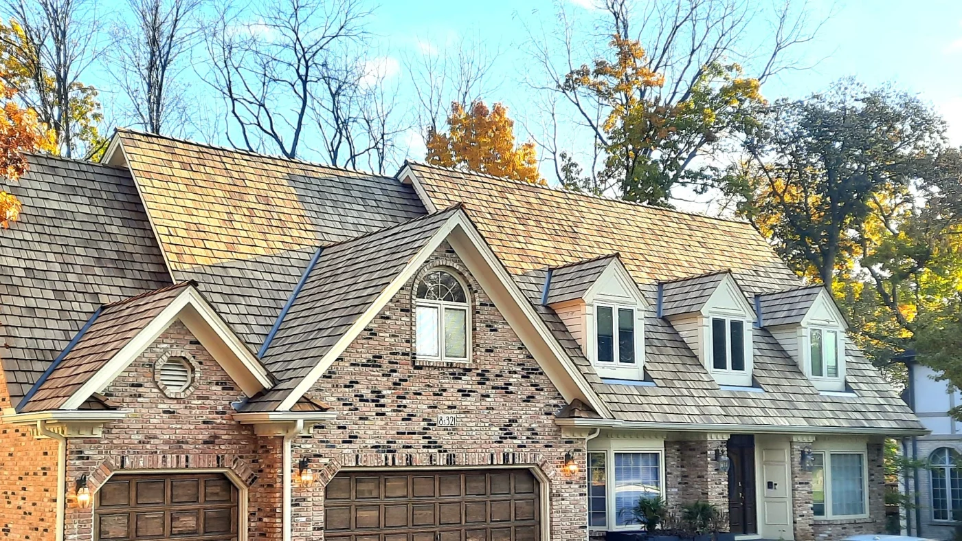 Exceptional Roof Repair Services | Northbrook, IL | Apex Exteriors, Inc. The front of a house with a light brown roof in Northbrook, IL, by Apex Exteriors, Inc.