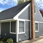 The front and side of a house partially with gray siding and white trim in Hinsdale, IL, by Apex Exteriors, Inc.