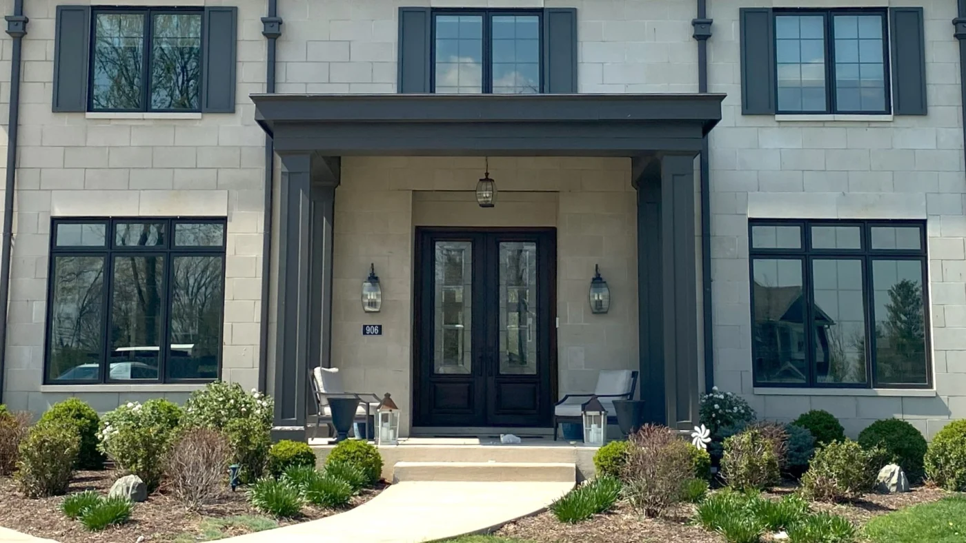 Masterful Door Replacement Services | Barrington, IL | Apex Exteriors, Inc. A close-up of the front of a house with gorgeous black entry doors in Barrington, IL, by Apex Exteriors, Inc.