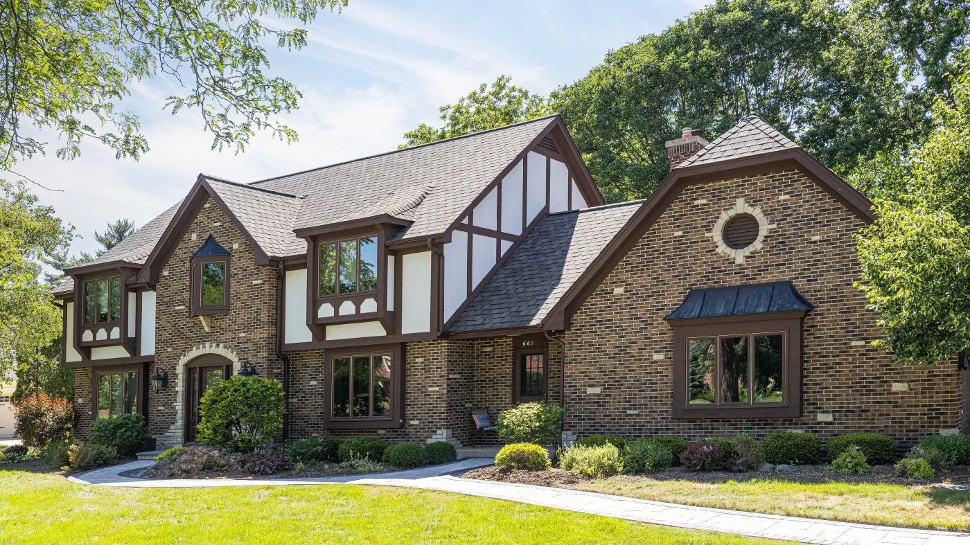 Remarkable Exterior Home Remodeling | Glenview, IL | Apex Exteriors, Inc. The front of a house with brown and white siding in Glenview, IL, by Apex Exteriors, Inc.