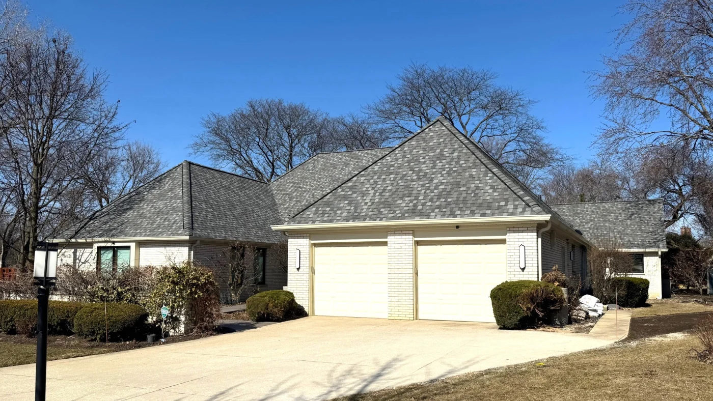 Spectacular Roof Replacement South Elgin Il Apex Exteriors The front of a house with a gray roof in South Elgin, IL, by Apex Exteriors Inc.