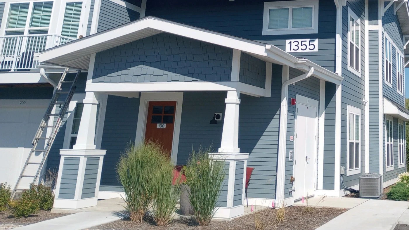 Modern entry with professionally installed doors that improve security, enhance energy efficiency, and complement the building's clean lines and contemporary exterior design.