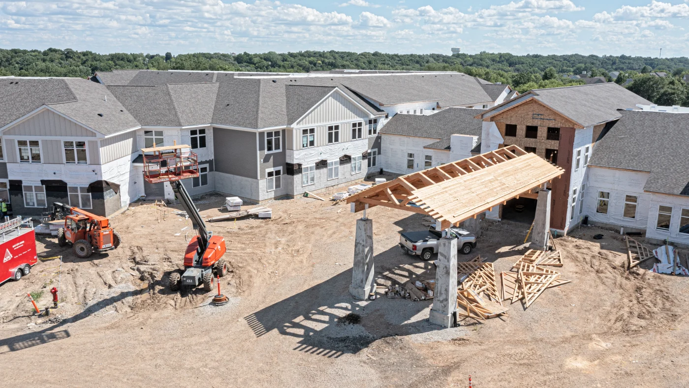 Reliable Commercial Roofing Contractor | Bartlett, IL | Apex Exteriors, Inc. Contemporary commercial building with a curved facade, dark metal roofing accents, and large window panels, showcasing clean lines and precision exterior detailing.