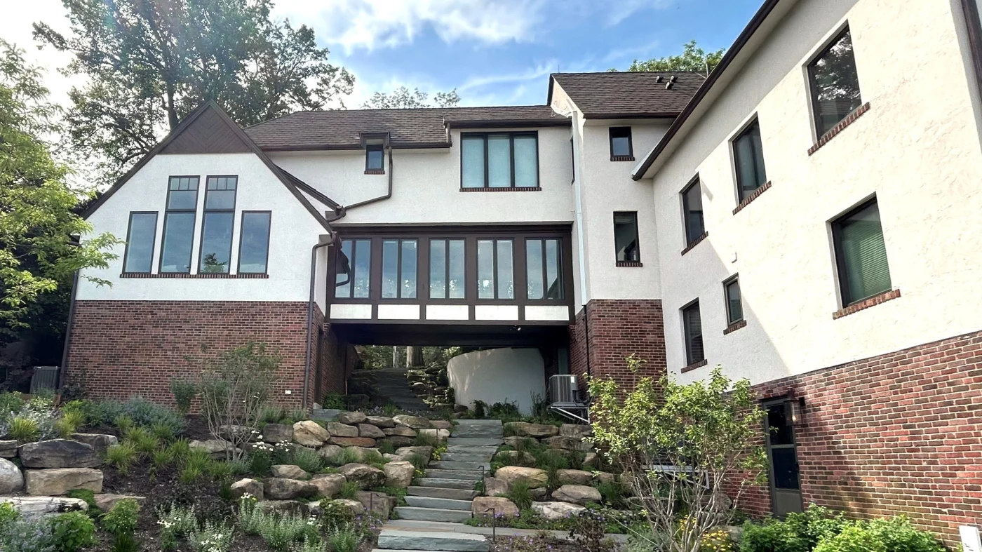 Reliable Gutter Installation | Bartlett, IL | Apex Exteriors, Inc. Contemporary farmhouse home with crisp white siding, black trim, and a dark shingle roof, featuring cleanly installed black gutters that complement the sharp rooflines and modern exterior details.