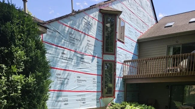 Reliable HOA Exterior Services | Bartlett, IL | Apex Exteriors, Inc. Professional exterior maintenance is in progress on a modern multi-unit home, showcasing durable roofing, clean siding, and well-maintained community surroundings.