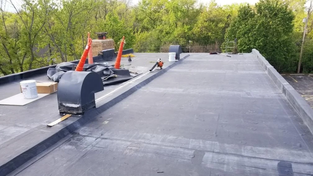 Outstanding Commercial Roof Replacement Elgin Il Apex Exteriors Inc Commercial flat roof replacement in progress with new membrane installation, ensuring improved durability, proper drainage, and long-term weather protection.