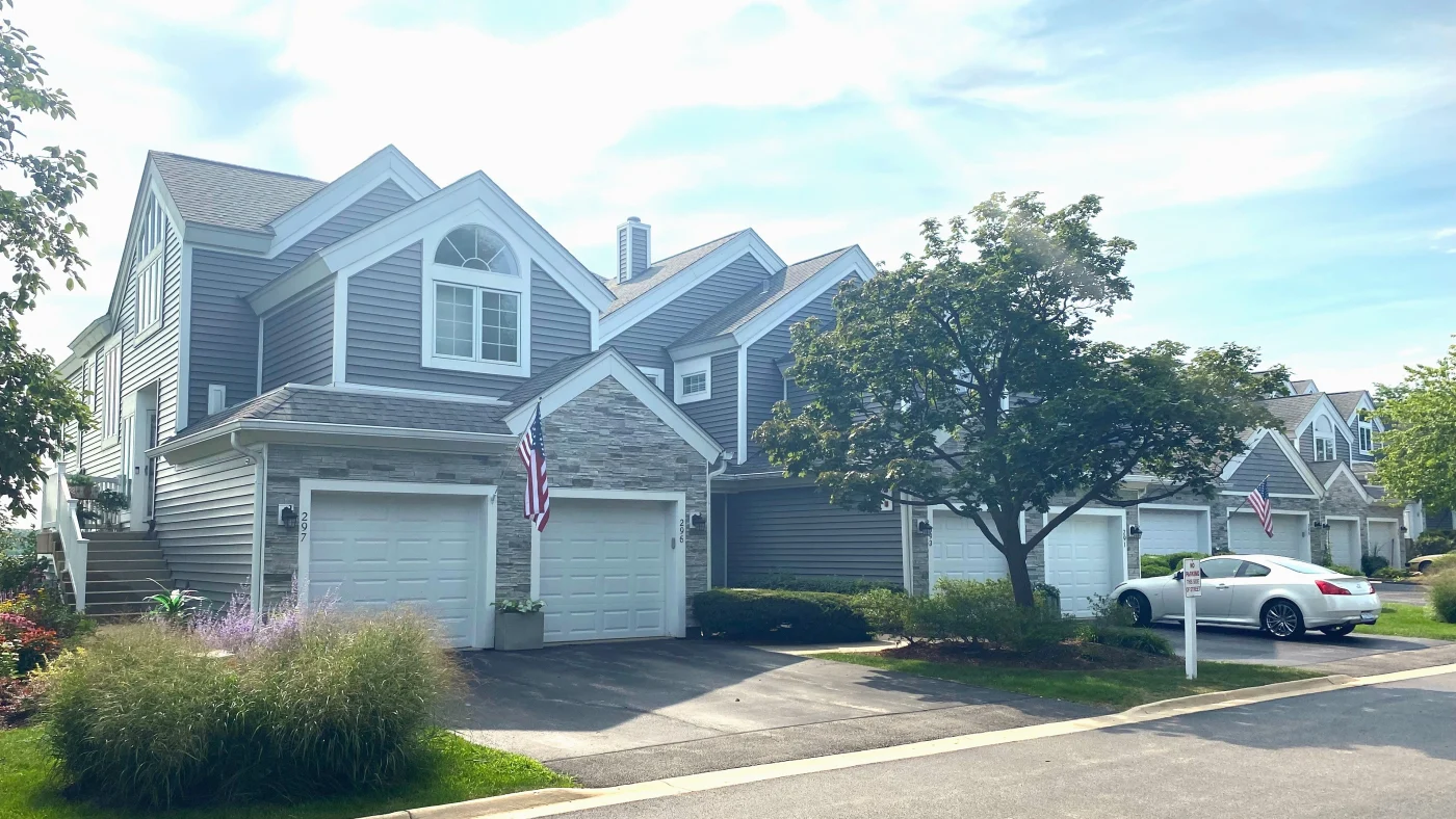 Outstanding HoA Exterior Services | Elgin, IL | Apex Exteriors Inc. Row of attached townhomes with updated siding, stone accents, and coordinated exterior finishes, showcasing clean installation work and curb appeal improvements.