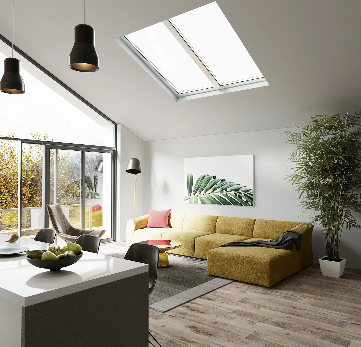 The interior of a room with high, angled ceilings. One wall of the room is made of glass, including large windows and a sliding door, but the others, along with the ceiling, are white. The flooring is light gray and brown wood, and there is a white-topped gray island visible on the left. To the right, there is a yellow couch. Above the couch, in the ceiling, is a large skylight.