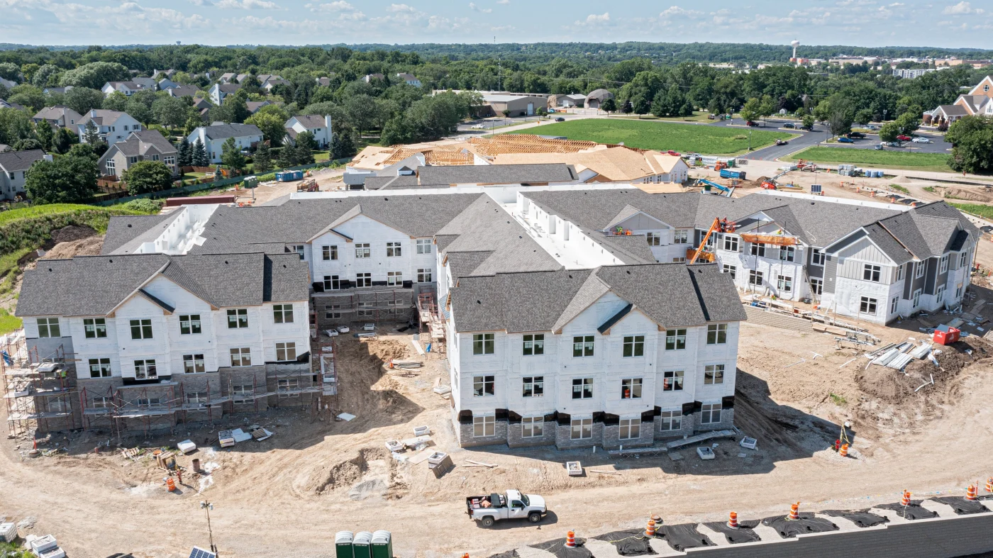 Exceptional Multi-Family Exterior Services | Bartlett, IL | Apex Exteriors, Inc. Newly completed multi-family community with coordinated siding, trim, and roofing, featuring clean lines, balanced color contrast, and well-maintained landscaping throughout the property.