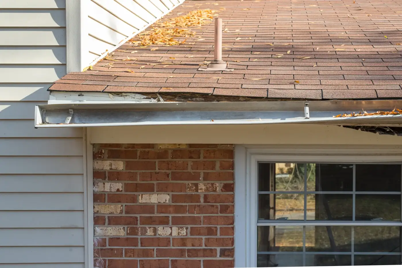 A close-up view of a seamless gutter system with new components.
