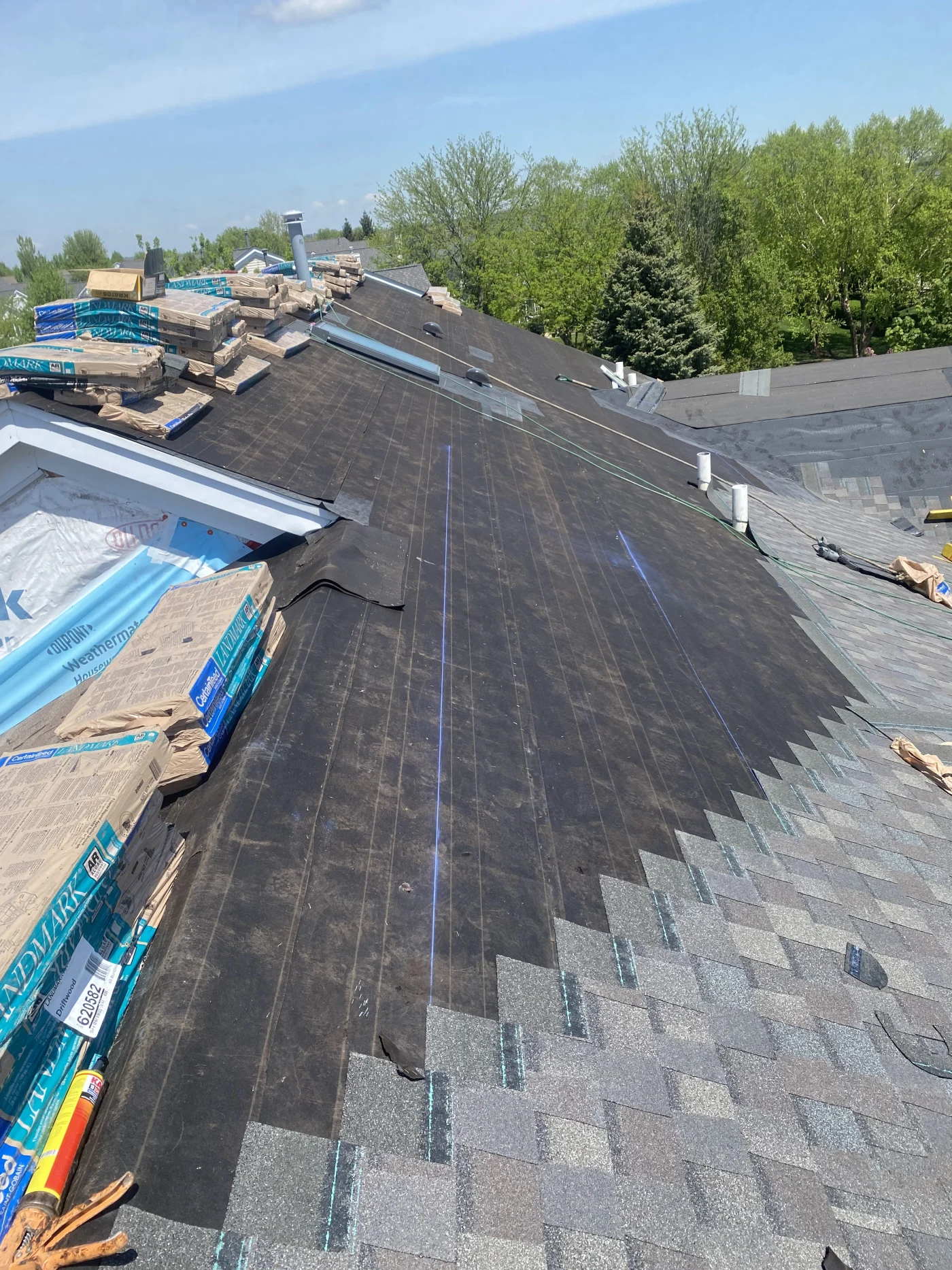 A drone shot from above of a 2-story residential home with a brand new roof.