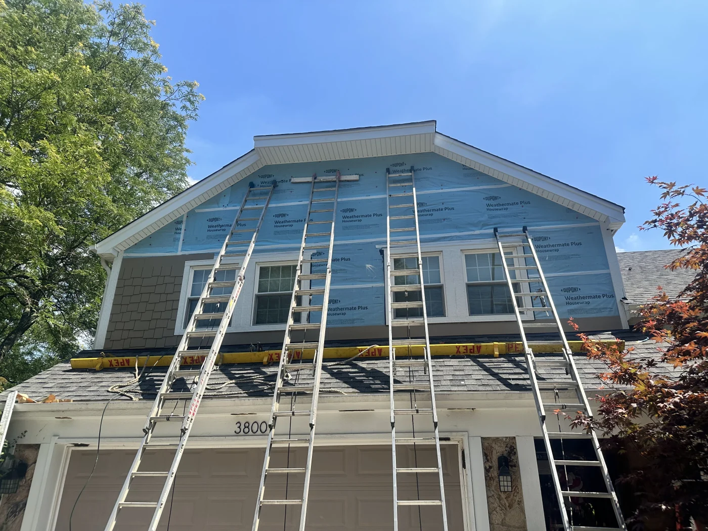 A side view of newly installed siding on a residential property.