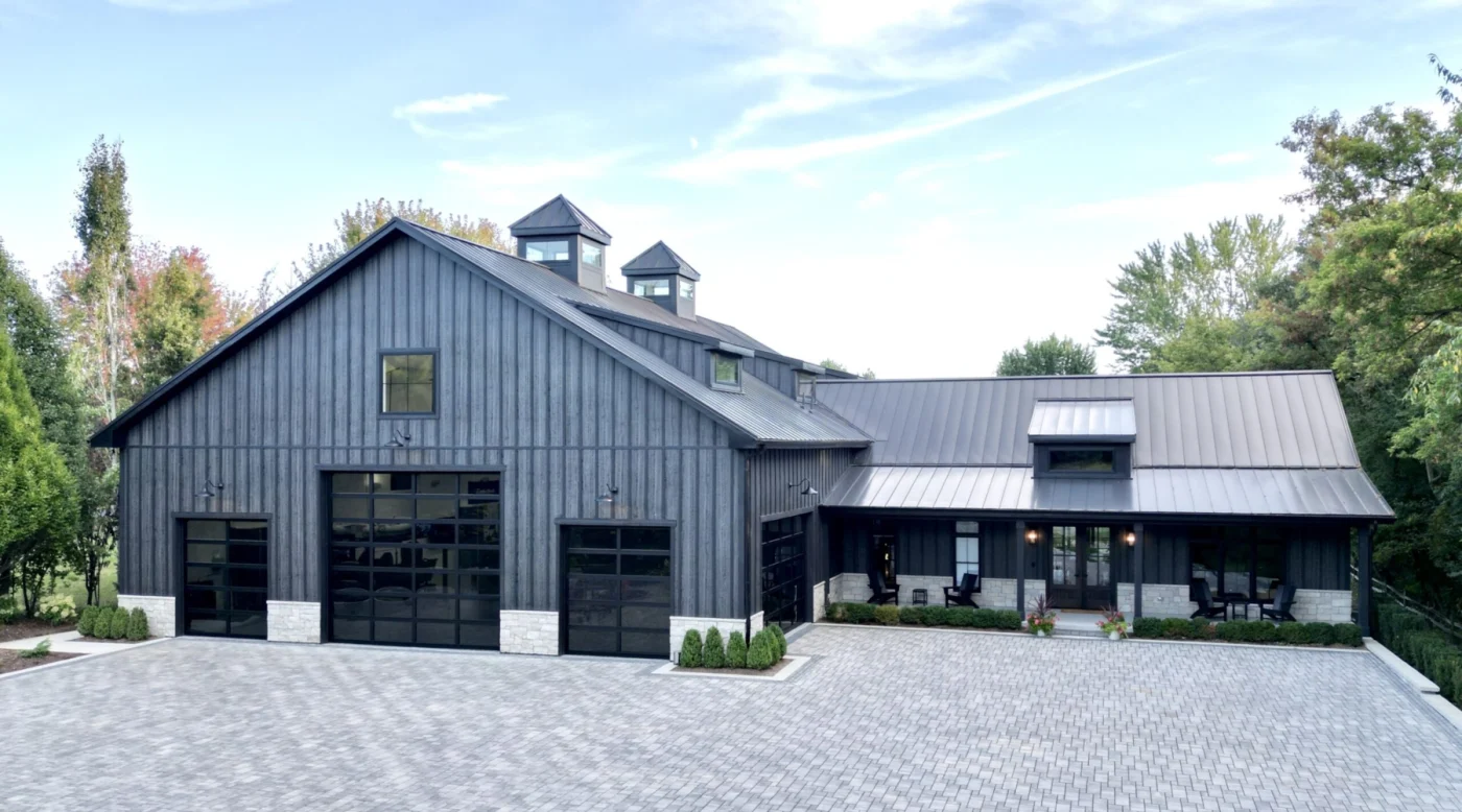 Expert New Home Construction | Wayne, IL | Apex Exteriors Inc. Modern barndominium iwth board and batten siding and a black standing seam metal roof.